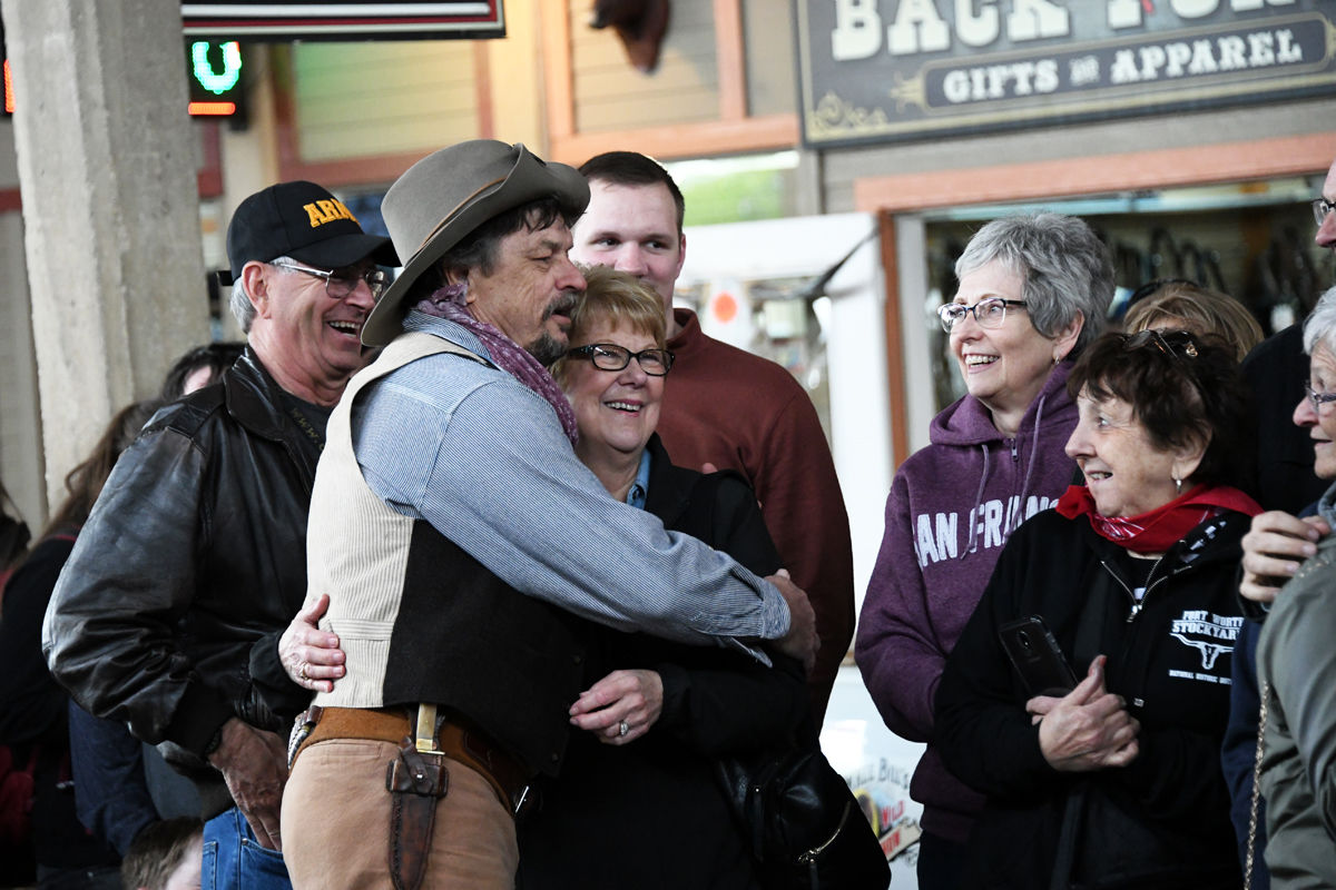 048 Sharon Nelson gets a hug from the cowboy as Mary Carlson and Trudy Anderson watch.JPG